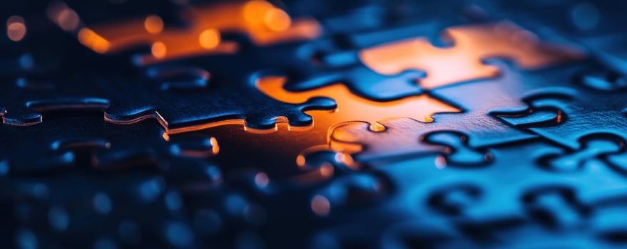 Puzzle pieces closeup, dark background, warm light, solution concept photo