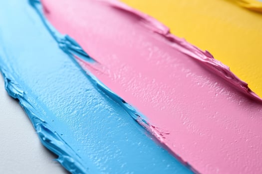 Pink, blue, yellow paint strokes, closeup, studio, textured background, design element photo