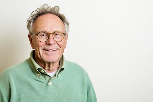 Portrait of smiling mature man with glasses on white background photo
