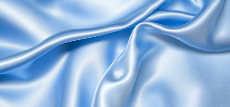 Elegant light blue silk fabric background with soft textures and smooth drapes for fashion and design photo