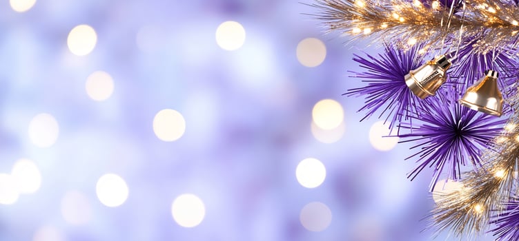 Festive holiday background with gold and violet pine needles twinkling lights and golden bells photo