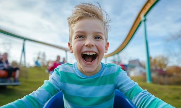 Excited boy ride amusement park roller coaster fun happiness child portrait adventure photo