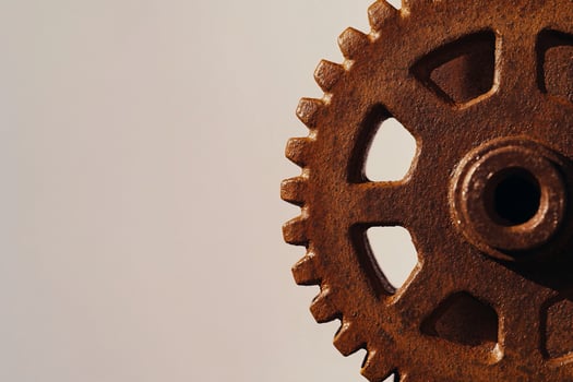 Rusty gear closeup, studio backdrop, industrial mechanism detail, design element photo