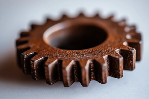Rusty gear, closeup, white background, industrial setting, mechanics photo