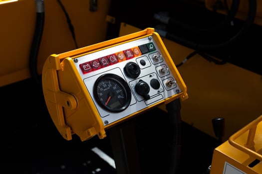 Yellow control panel for special equipment for pile driving. Tachometer sensor for determining engine speed of special equipment. Toggle switches and switches for controlling pile driving equipment photo