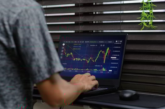 Home Office Setup with Laptop Displaying Stock Market Analysis photo
