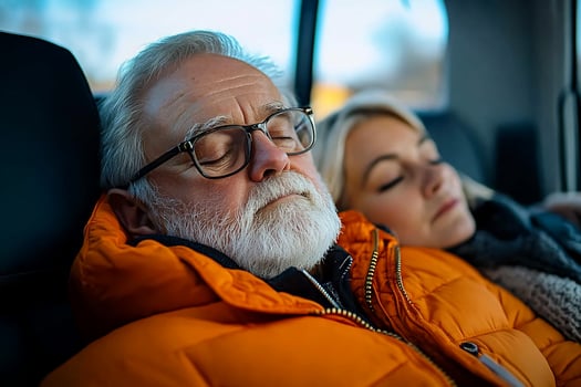 Elderly man and woman sleeping car backseat, winter, travel photo