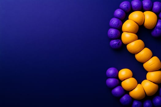 Purple yellow beads form 'S' on blue background photo