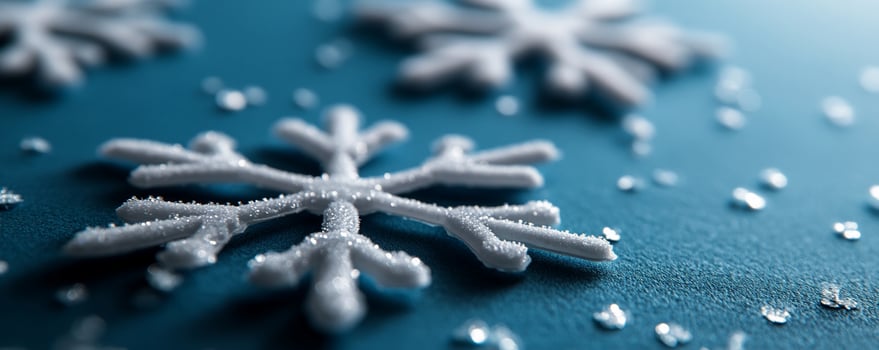 Closeup white snowflakes on blue, glitter background. Holiday card design photo