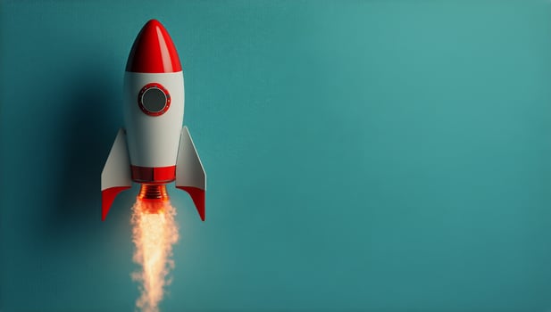Rocket Launches Into the Sky, Leaving Behind a Trail of Smoke and Fire in the Bright Blue Background. photo