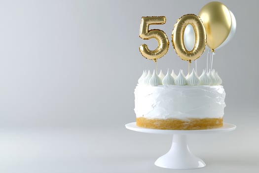 Festive celebration cake with golden number balloons for anniversary milestone photo