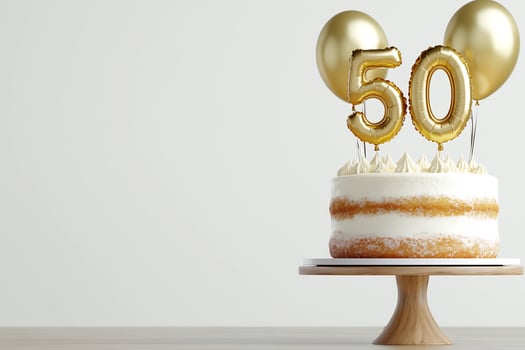 Festive milestone cake with golden balloons celebration dessert pastry birthday photo