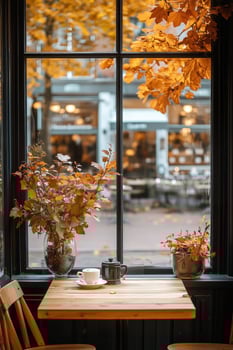 Cozy Cafe Interior With Autumn Leaves and Warm Drinks During a Peaceful Afternoon photo
