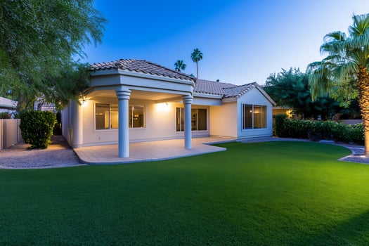 Modern home exterior with green lawn at dusk photo