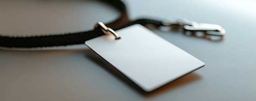 Blank ID badge lanyard on desk, closeup photo