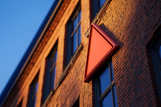 Red Triangle Sign Urban Brick Building Sunset photo
