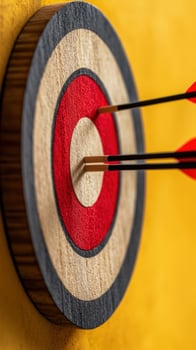 Arrows hitting bullseye on target, yellow background, success concept photo