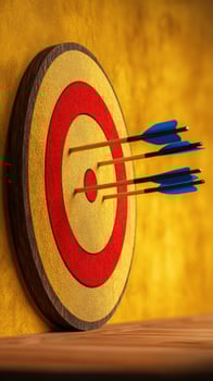Arrows hitting bullseye on target, wooden surface, yellow wall, success concept photo