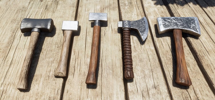 Collection of hammers and axes on wooden surface overhead view metal and wood tools for carpentry construction or woodworking photo