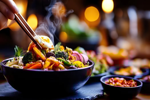 Person eating steaming Asian noodle bowl, restaurant background photo