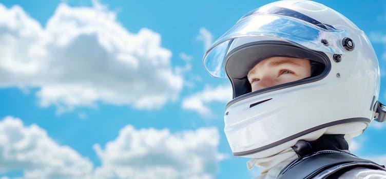 Racer head wearing motorsports helmet under blue sky photo