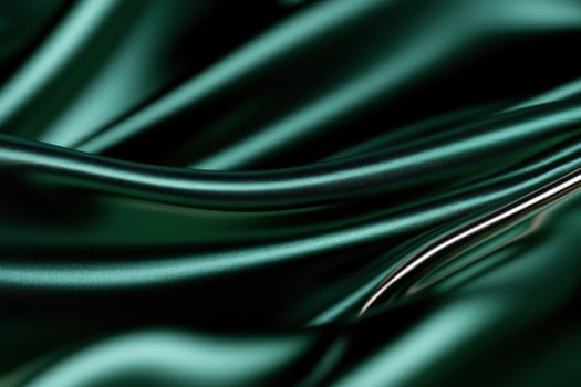 Emerald silk fabric drapes, studio shot, dark background, elegant texture photo
