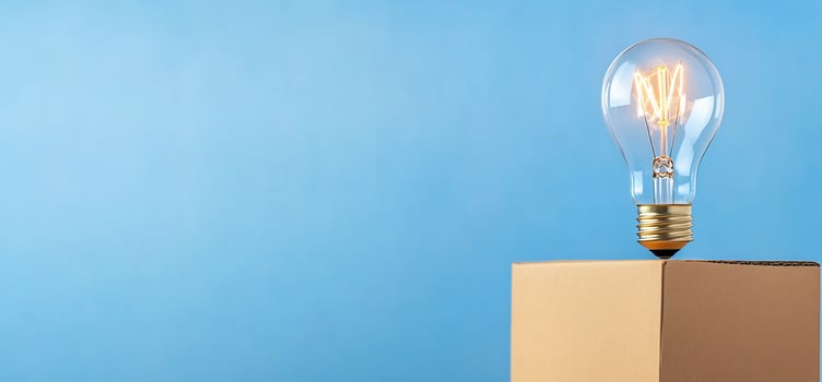 Light bulb on cardboard box symbolizing idea innovation and solution photo