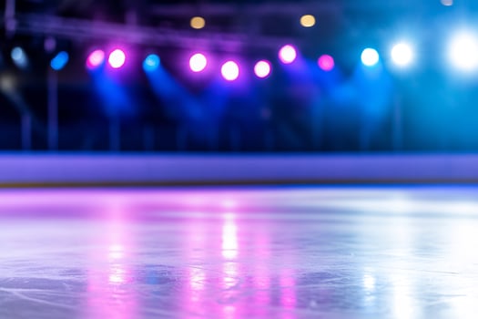 Ice skating rink with vibrant stage lighting for winter sports and entertainment photo
