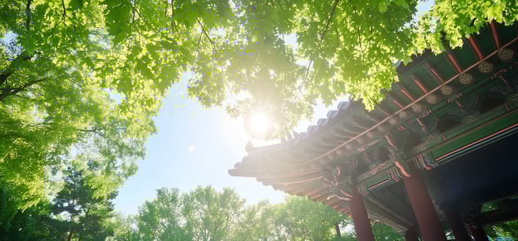 Sunlit green canopy framing architectural structure tranquil outdoor scene photo