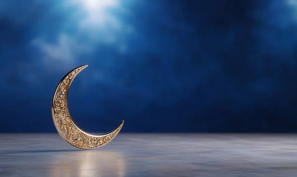 Golden crescent moon with ornamental design on blue backdrop photo