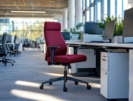 Red office chair, modern workspace, sunlit, busy background photo