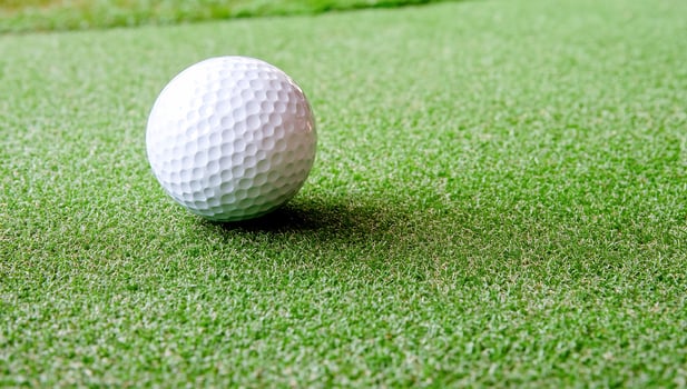 Golf ball on green grass field sport recreation activity photo
