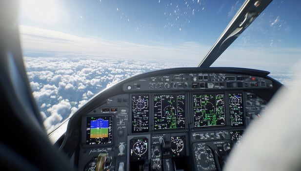Airplane cockpit view of sky clouds and flight control panel instruments photo