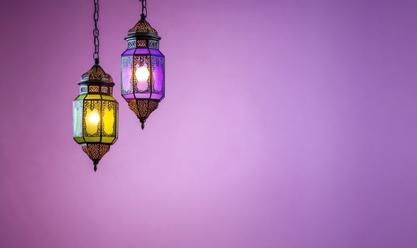 Ornate lanterns glow on purple background decoration photo