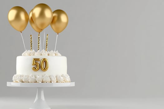 Celebratory cake with golden balloons and candles for birthday anniversary milestone occasion photo