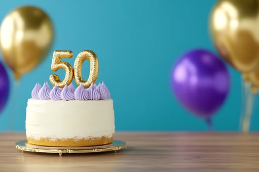 Celebratory cake with golden number and balloons for anniversary or birthday photo