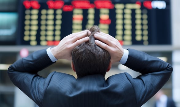 Financial stress man at stock market display photo