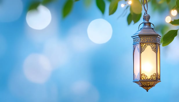 Glowing lantern hanging from branch in twilight garden with decorative light and ornate design photo