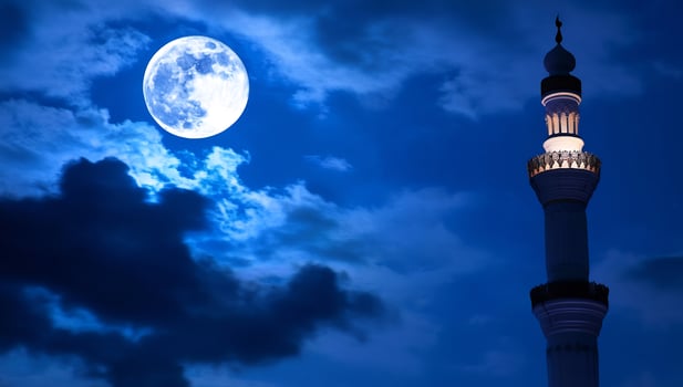 Mosque minaret under full moon night sky religious architecture photo