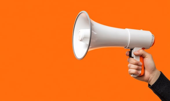 Megaphone announcement communication white with arm hand and orange background photo