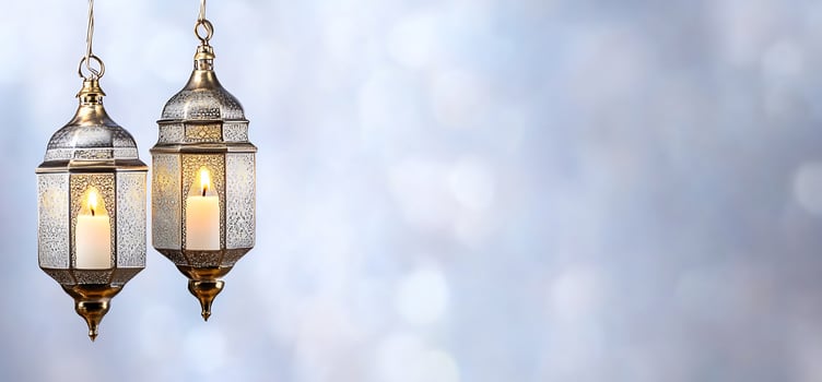 Decorative lanterns with candlelight on soft bokeh background photo