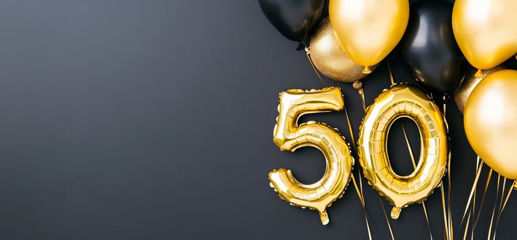 Golden number fifty balloons on gray background celebration concept photo