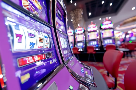 Row of purple slot machines in a casino gambling entertainment photo
