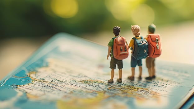 Miniature travelers with backpacks stand on a detailed world map looking forward to new adventure photo