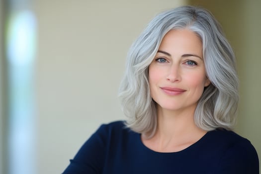 Elegant woman portrait with silver wavy hair clean beauty shot face of mature confident female photo