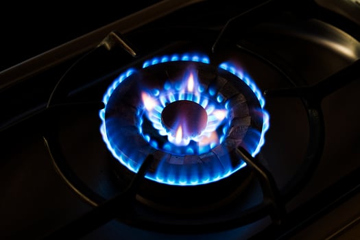 Burning gas, gas stove burner, hob in the kitchen on black background photo