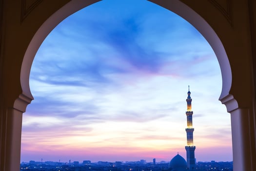 Minaret through archway at dusk skyline scenic view photo