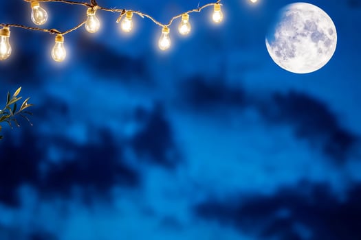 String lights and moon in night sky dark blue background photo