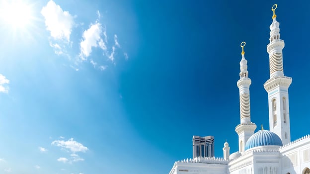Elegant mosque architecture against vibrant blue sky and white clouds photo