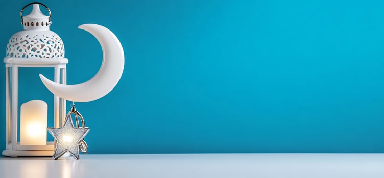 White lantern with crescent moon and star on blue background photo